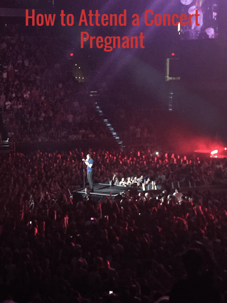Imagine Dragons Dan Reynolds singing on stage. 