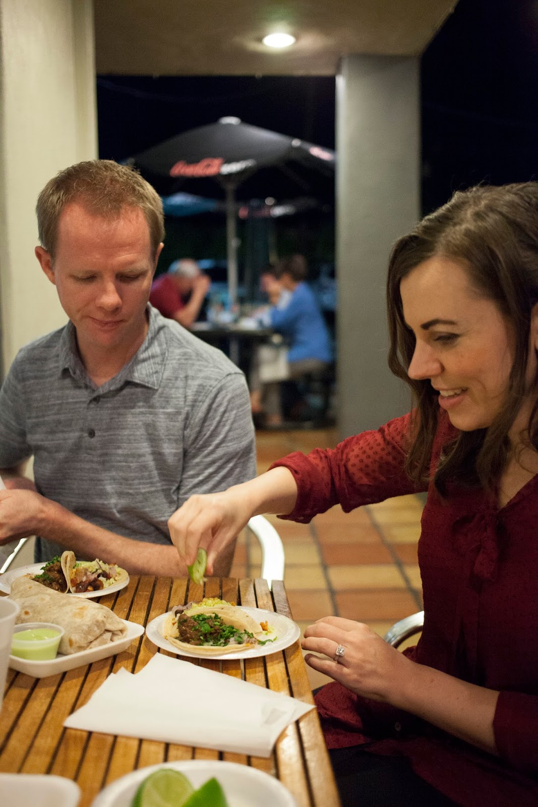 Couple on a taco date about to eat tacos together. 