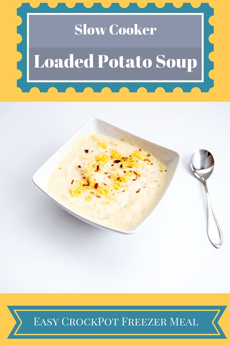 Loaded basked potato soup with soup in a white bowl with a spoon next to it. 