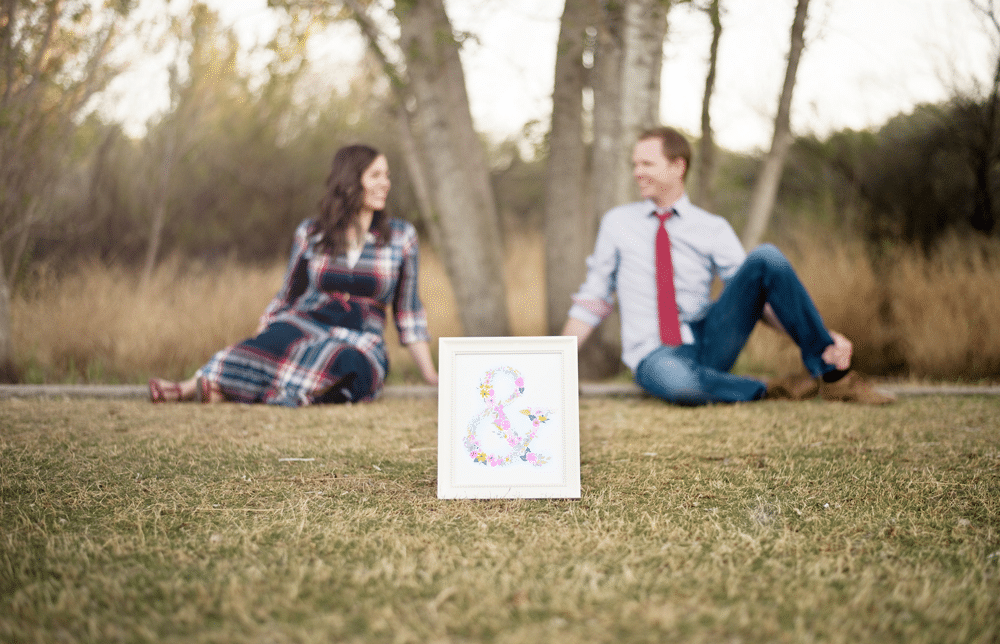 Couple taking anniversary pictures with a cute sign. 