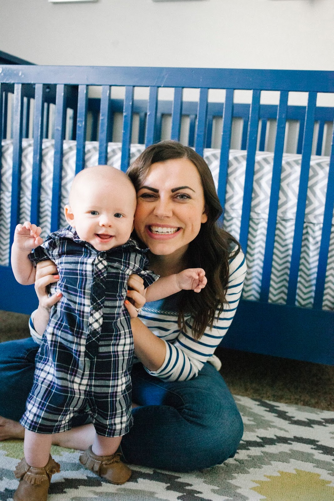 Mom with a five month old baby in a nursery. 