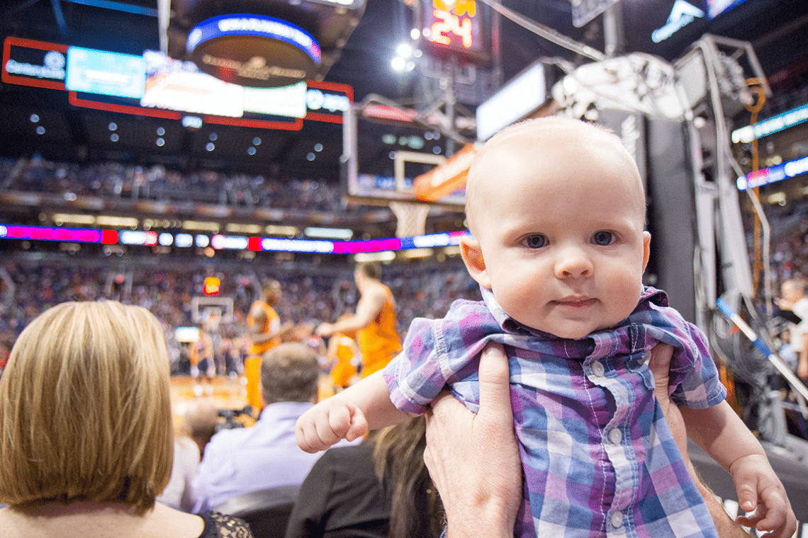 Taking a baby to a basketball game. 