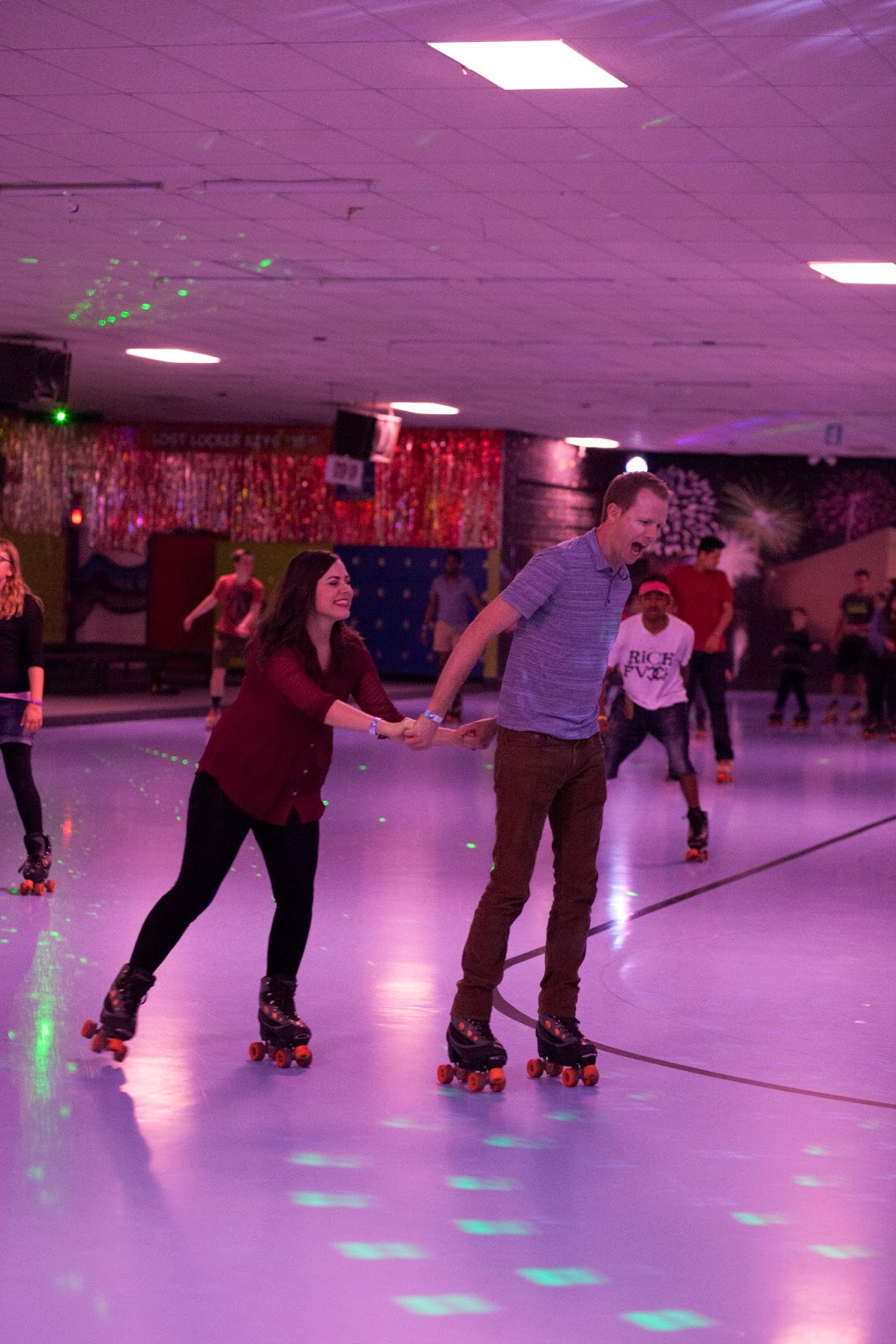 Holding hands while roller skating. 