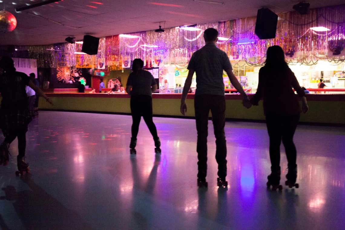 Holding hands roller skating. 