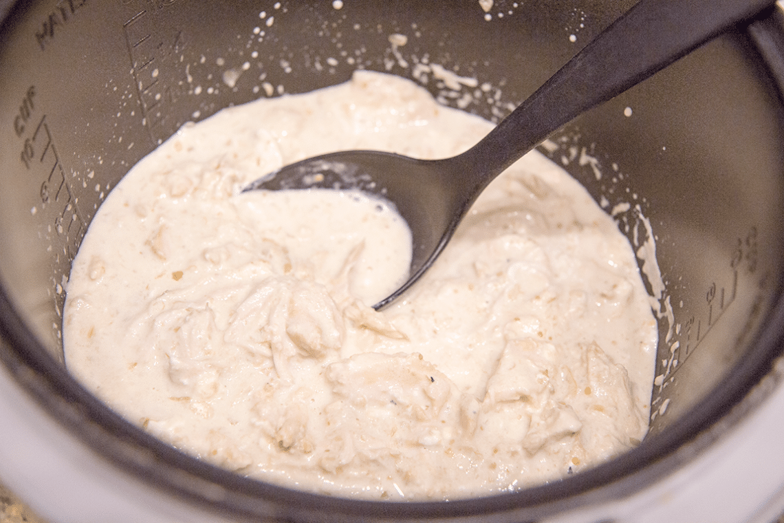 Process shot sharing how to stir in cream cheese for salsa verde crock pot chicken. 