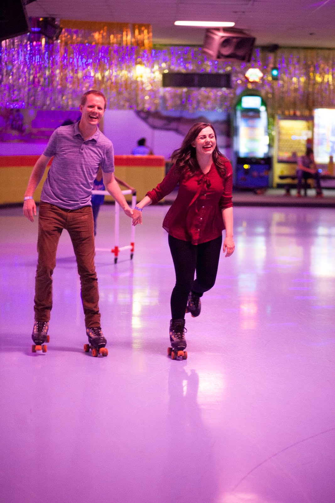 Holding hands roller skating date night. 