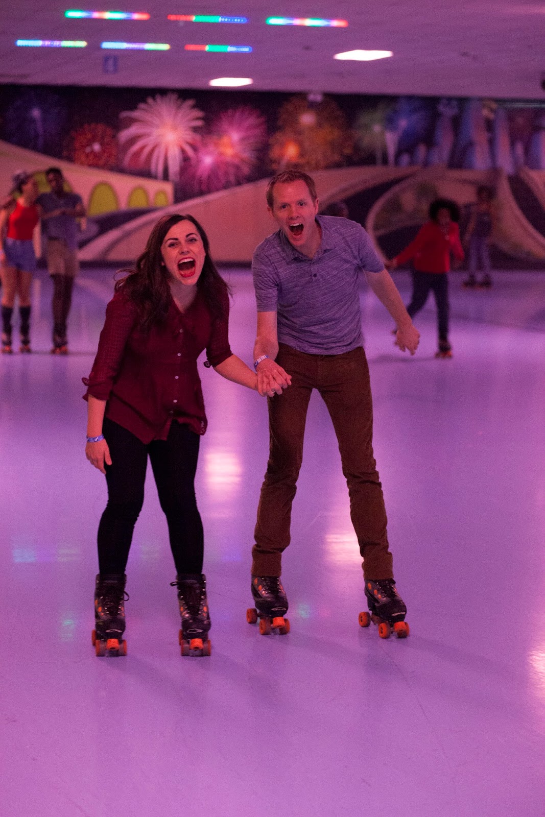 Couples skate roller skating. 