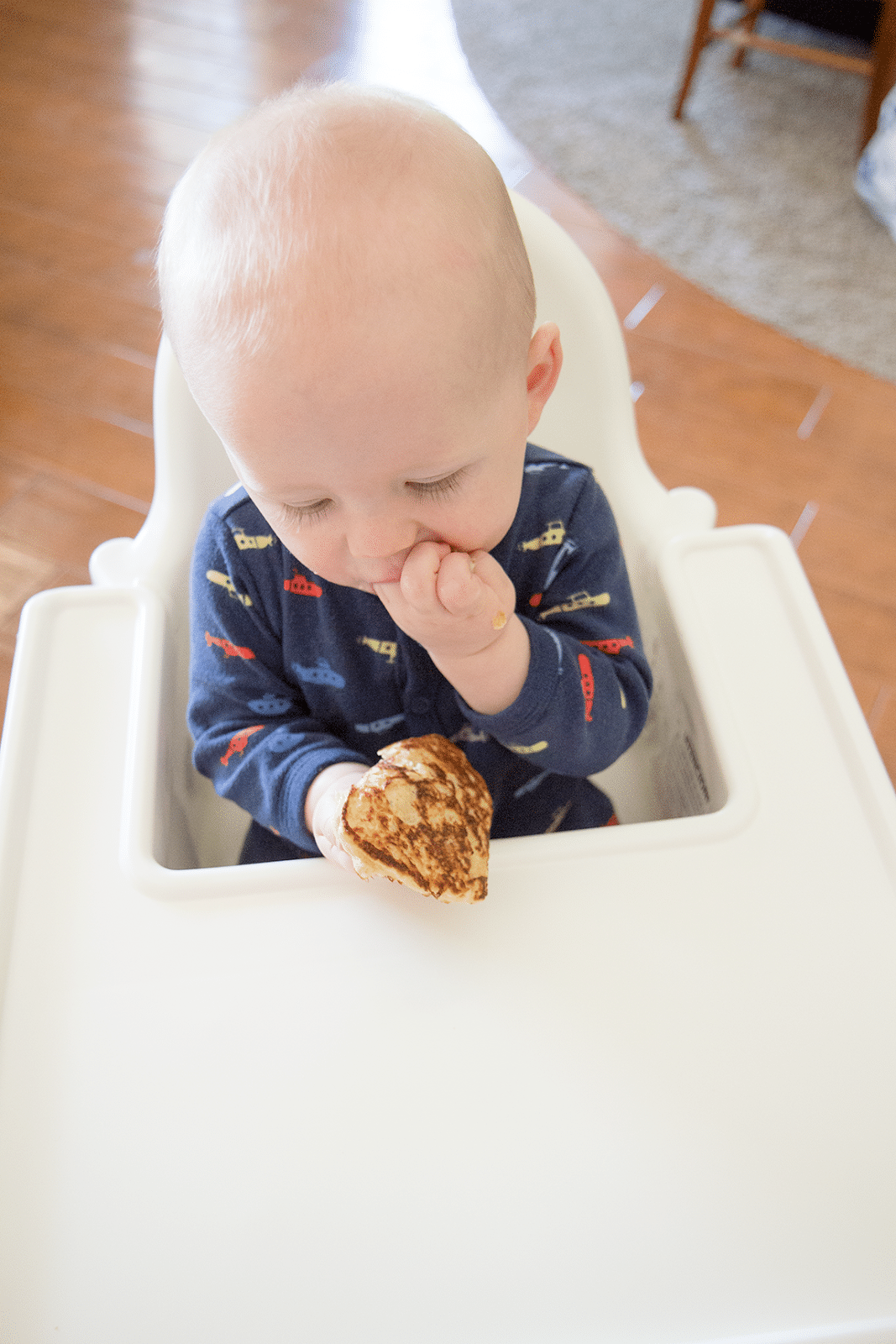 Baby eating oatmeal pancakes. 