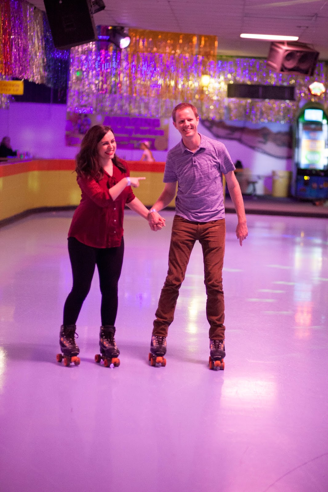 Holding hands on a roller skating date night. 