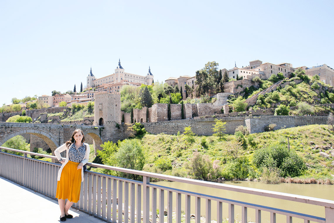 Woman showing the skyline in Toledo, Spain. 