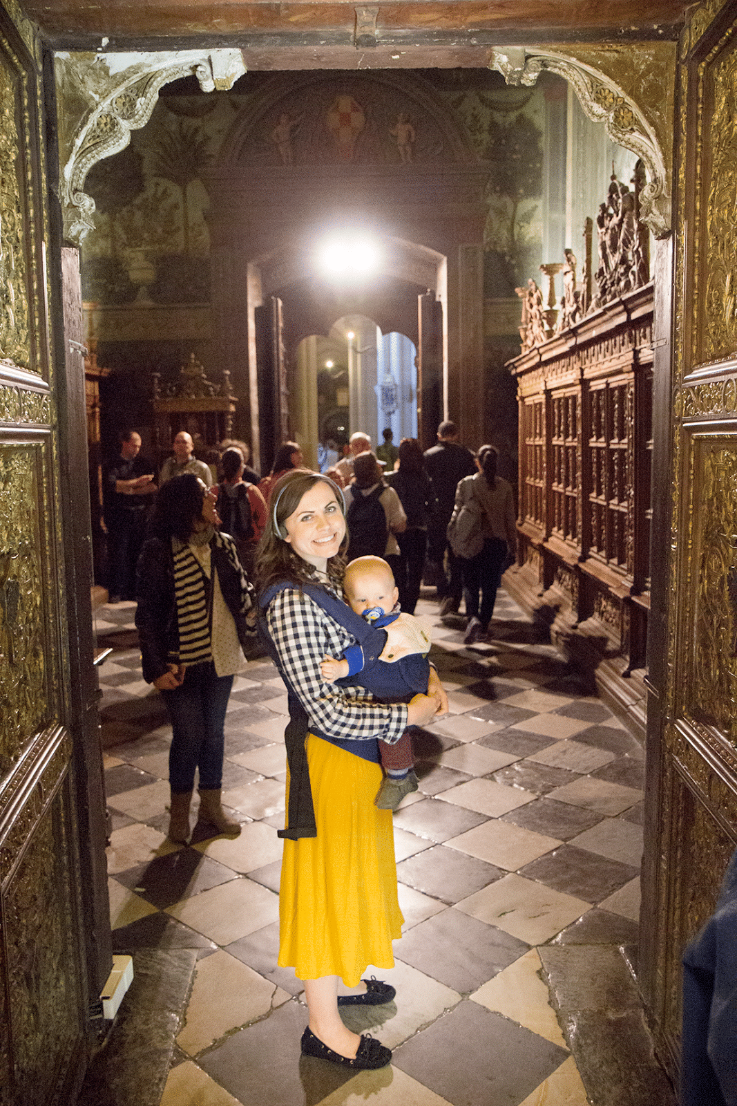 Mom with a baby walking into the Toledo Cathedral in Toledo Spain. 
