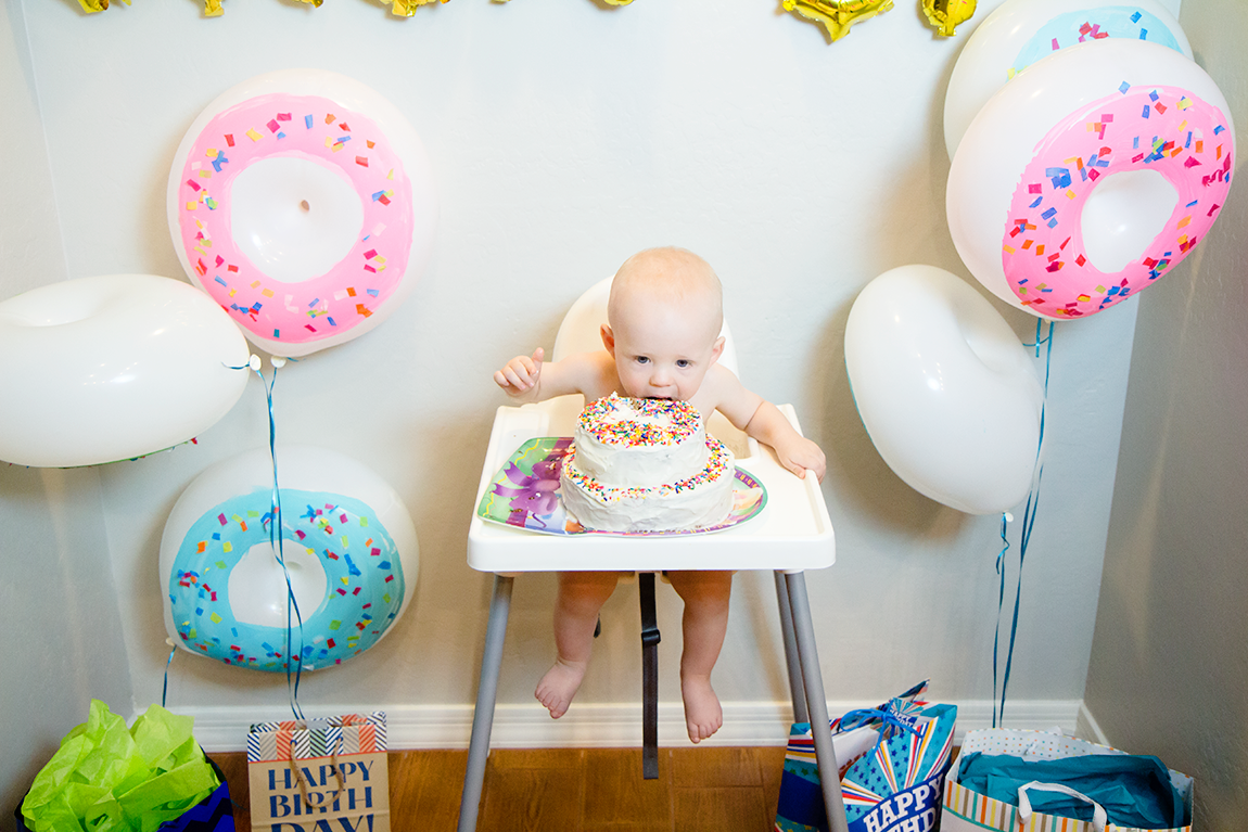 donut first birthday cake with baby licking the cake. 