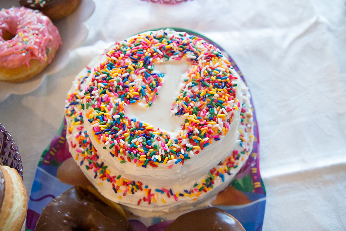 donut grow up cake covered in sprinkles. 