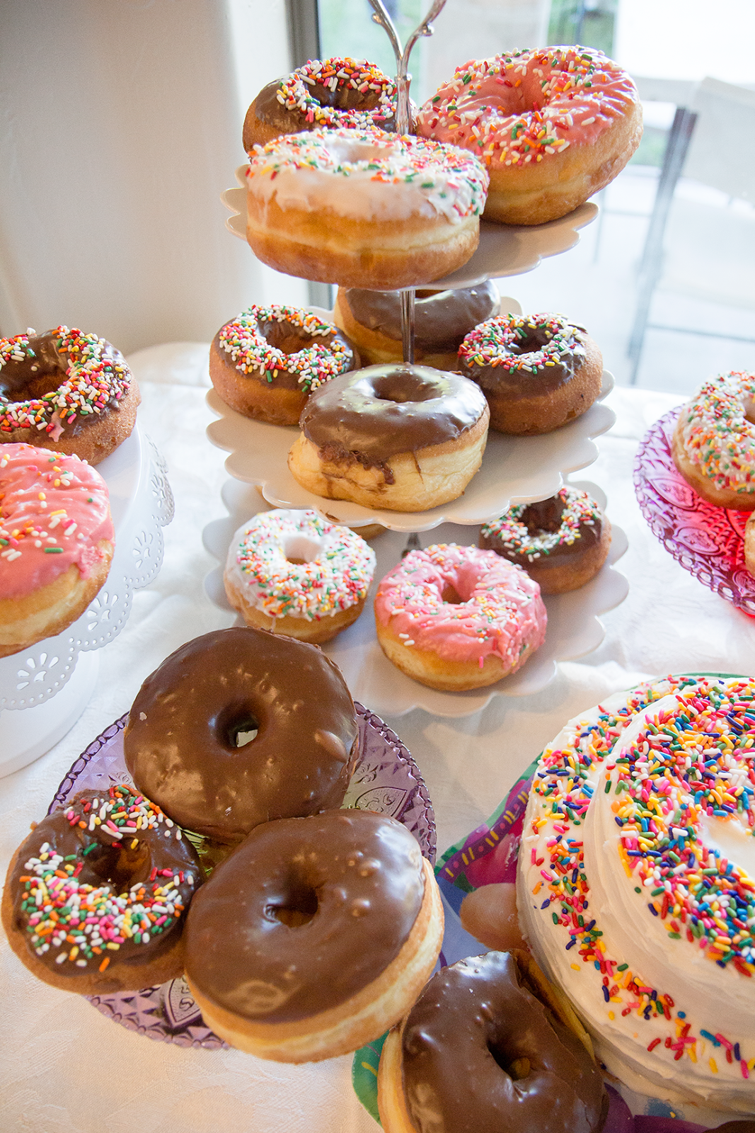 donut grow up theme birthday party with donut cake towers. 