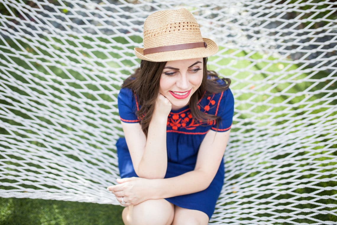 Woman sitting on a hammock contemplating life. 