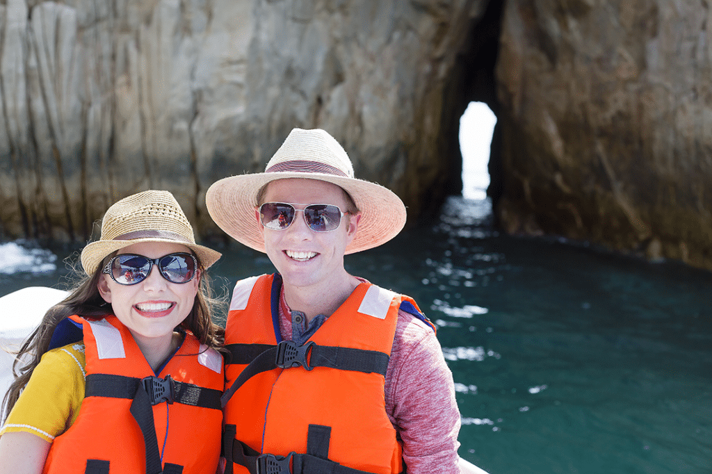 Couple visiting Lover\'s Beach in Cabo. 