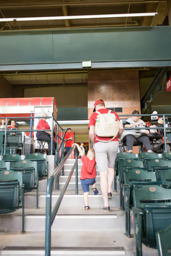 Father taking kids to a baseball game. 