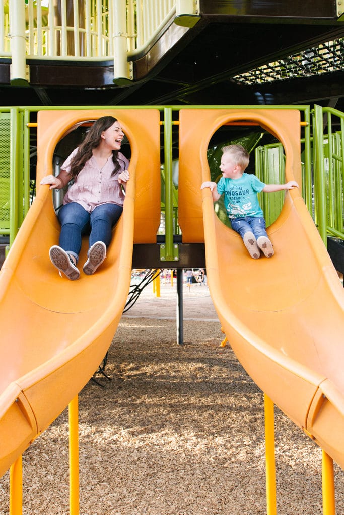 racing down slides on family park day