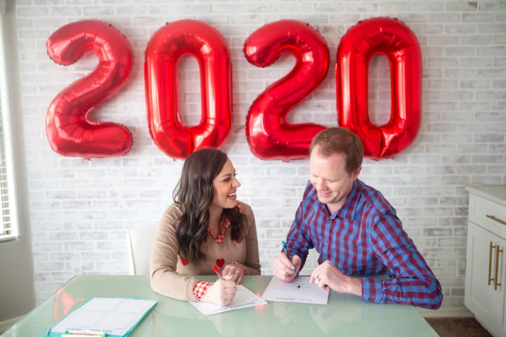 Couple sitting down to set goals together. 