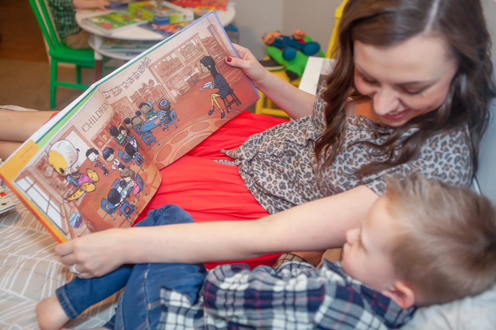 Mom reading books to her kids. 