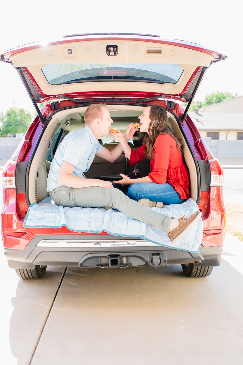 Couple enjoying a date night picnic in the car. 