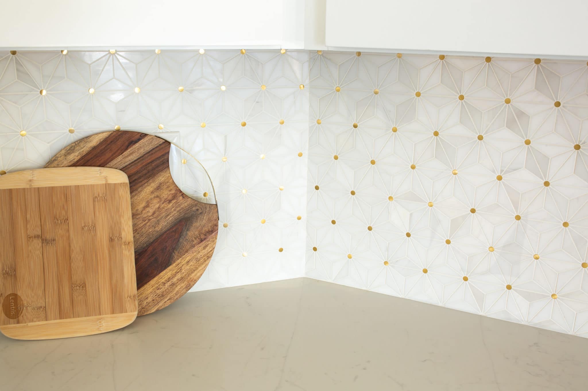 White tile backsplash with white kitchen cabinets. 