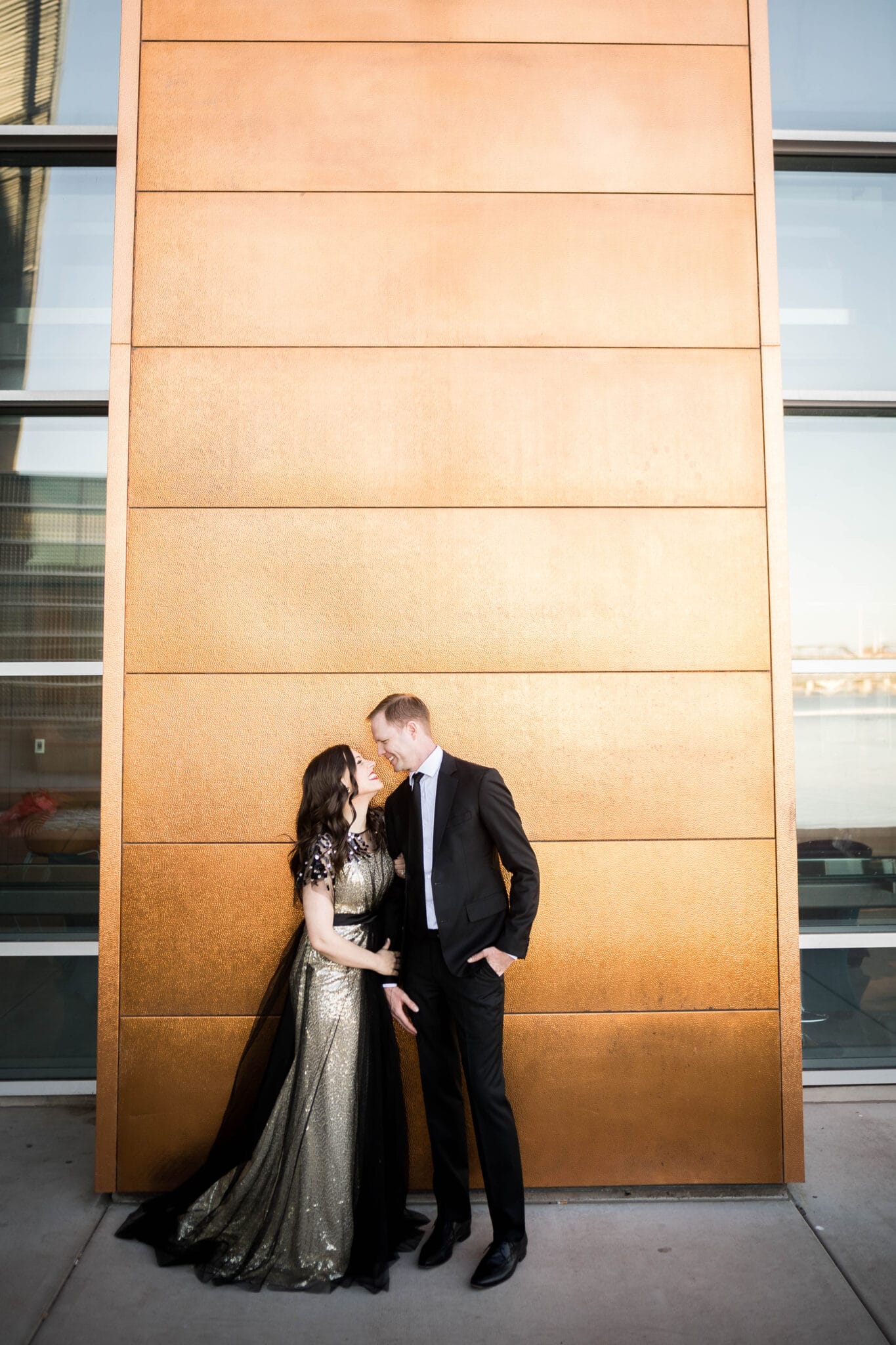 Golden Anniversary photo in front of golden backdrop. 