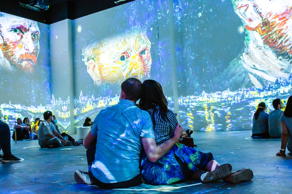 Couple immersed in the Van Gogh Experience for date night. 