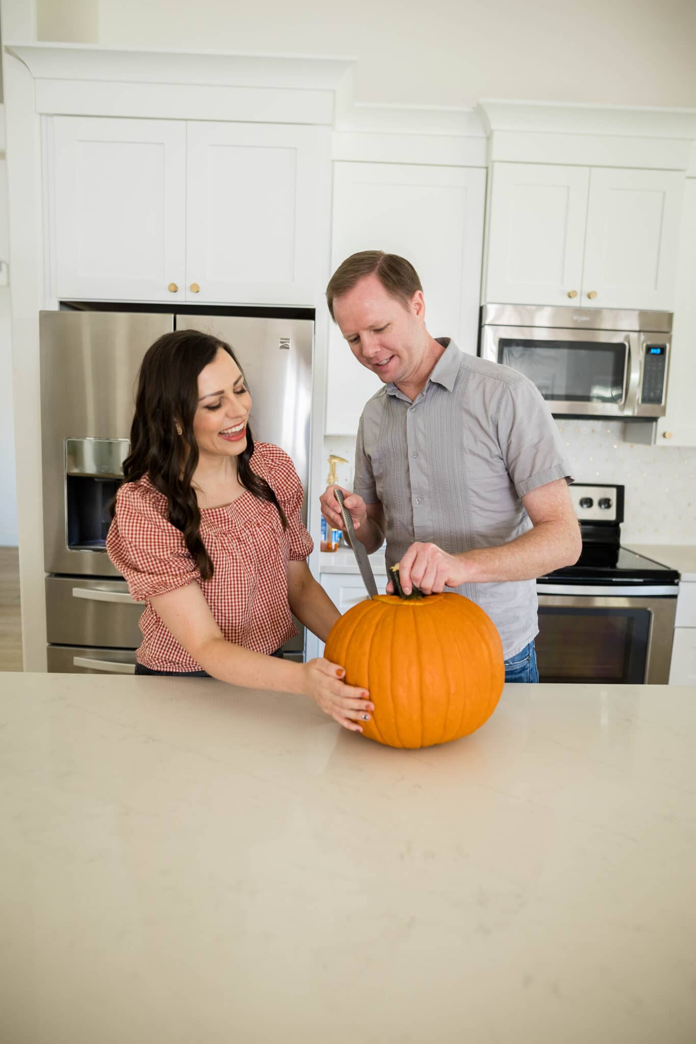 Pumpkin Carving Ideas with a couple carving pumpkins for date night.