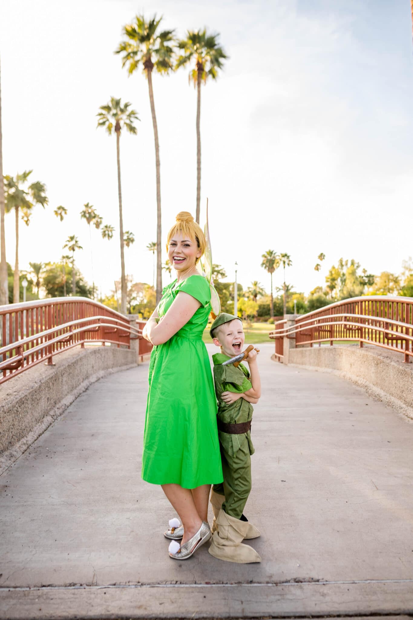Mom dressed as Tinkerbell and Peter Pan Costume on her son. 