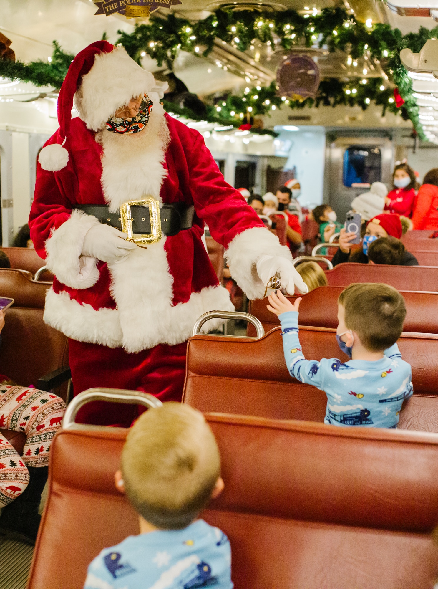 The Polar Express AZ Santa gifting a bell. 