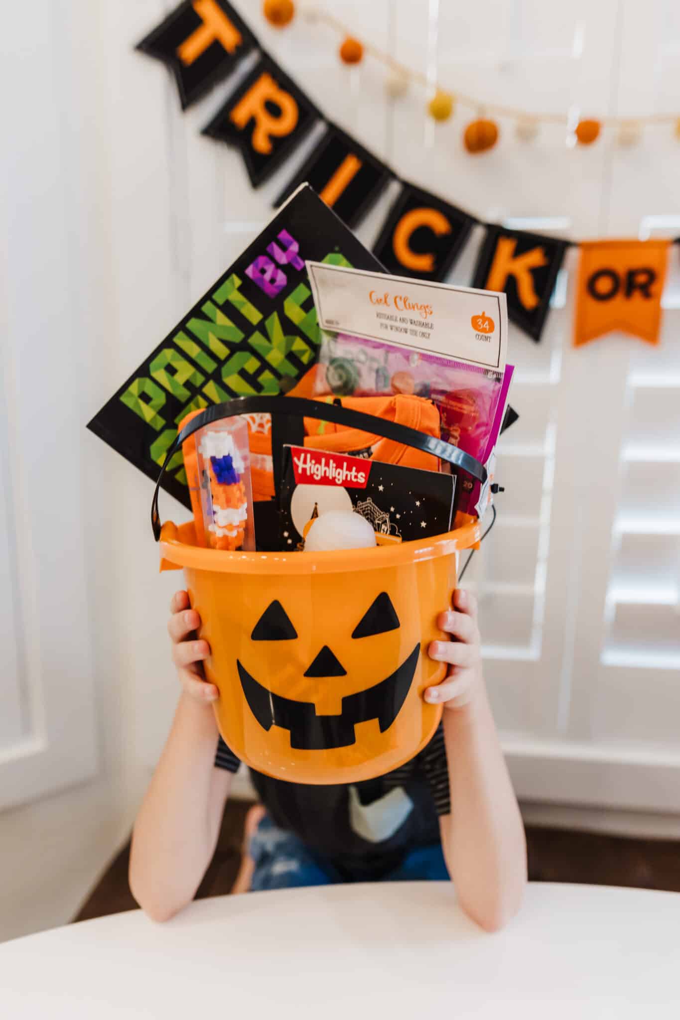 child holding up their Spooky Basket. 