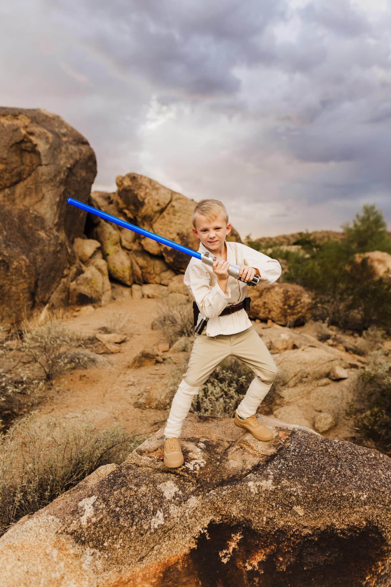 DIY Luke Skywalker Costume being modeled posing with a lightsaber. 
