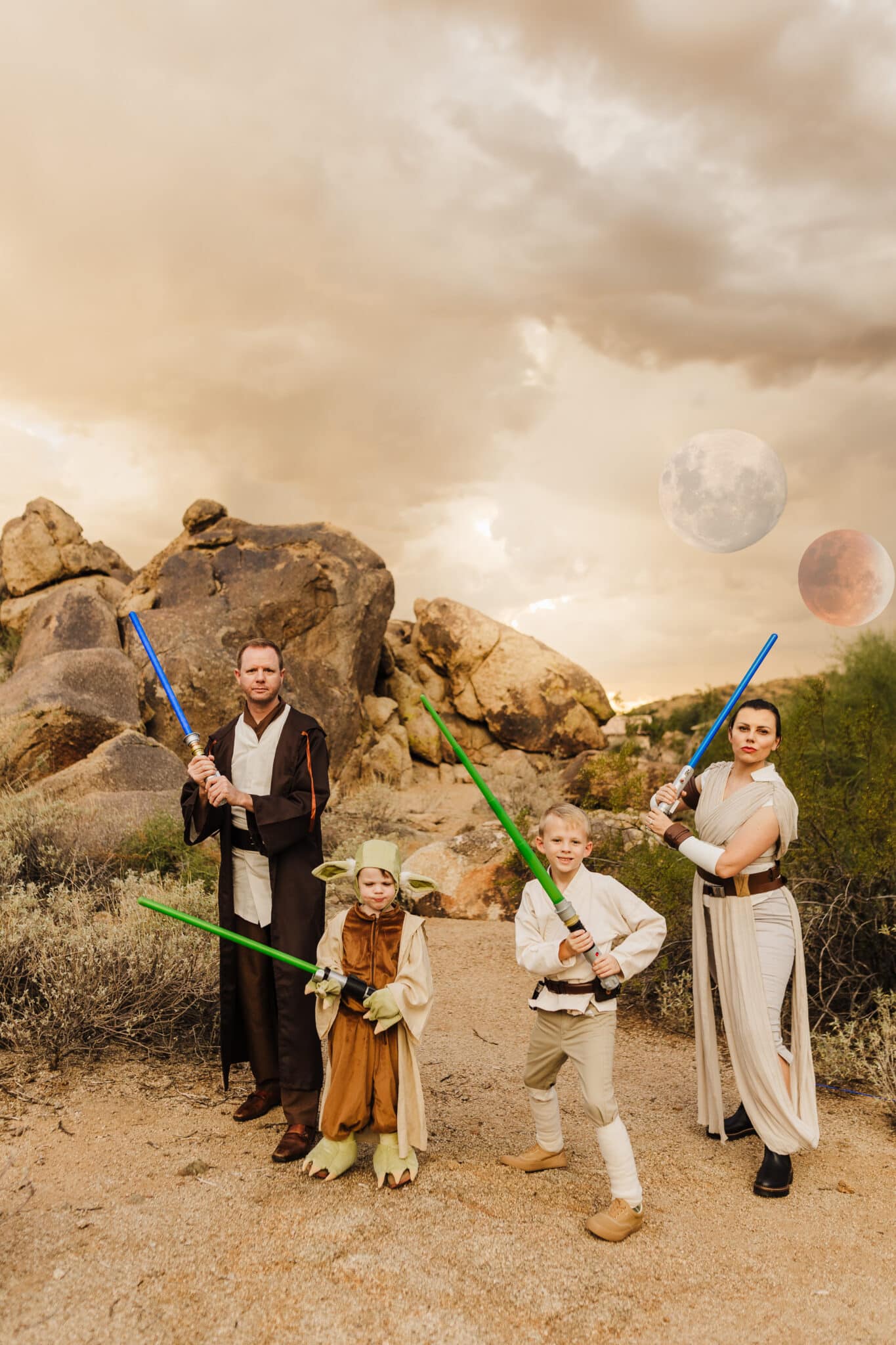Family Star Wars Jedi Costume with a family dressed as Obi Wan, Yoda, Luke Skywalker, and Rey all holding lightsabers. 