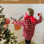 Kid playing Pin the Nose on Rudolph.