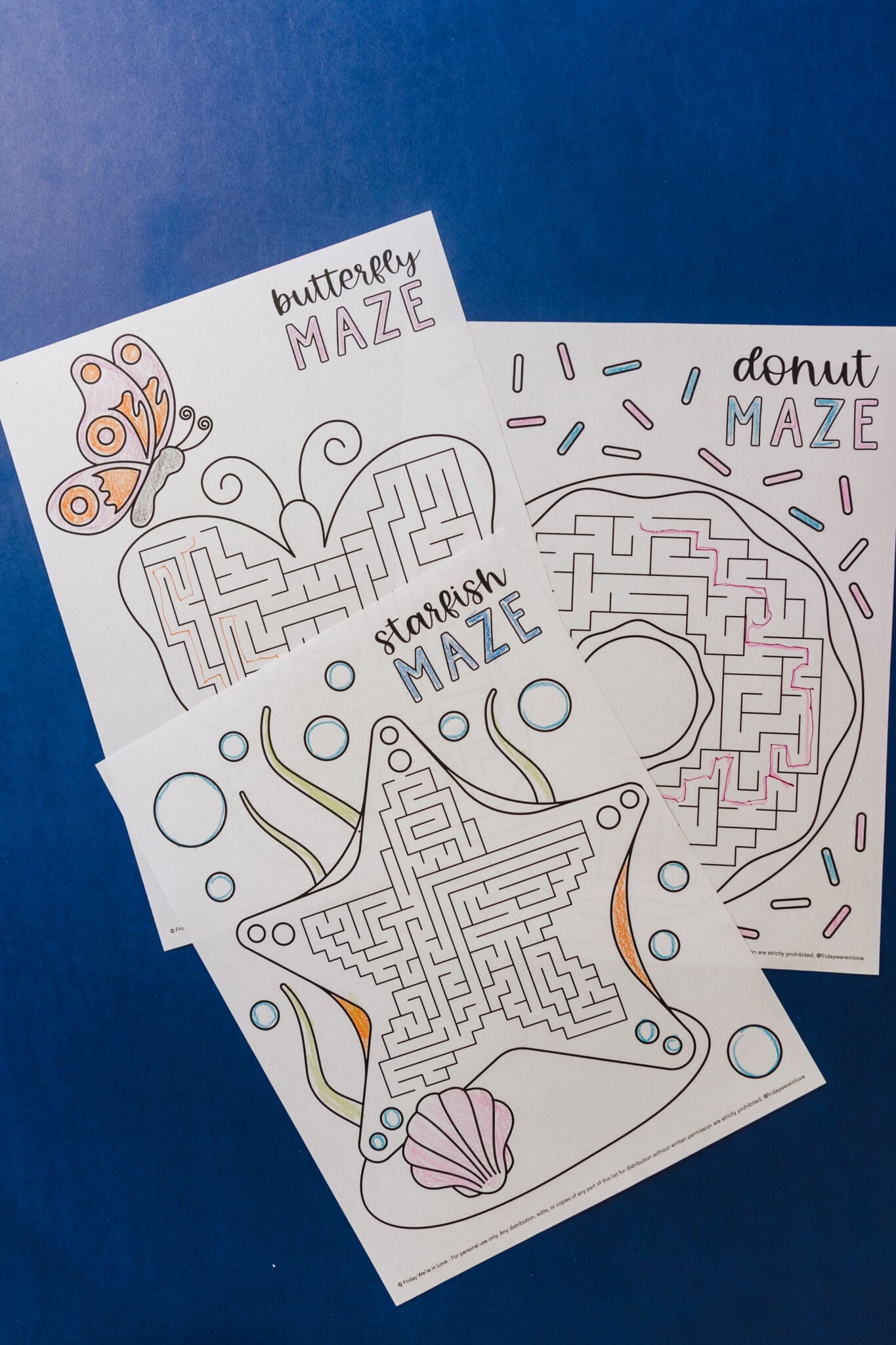 Printable mazes for kids: three maze printouts on a. blue backdrop. 