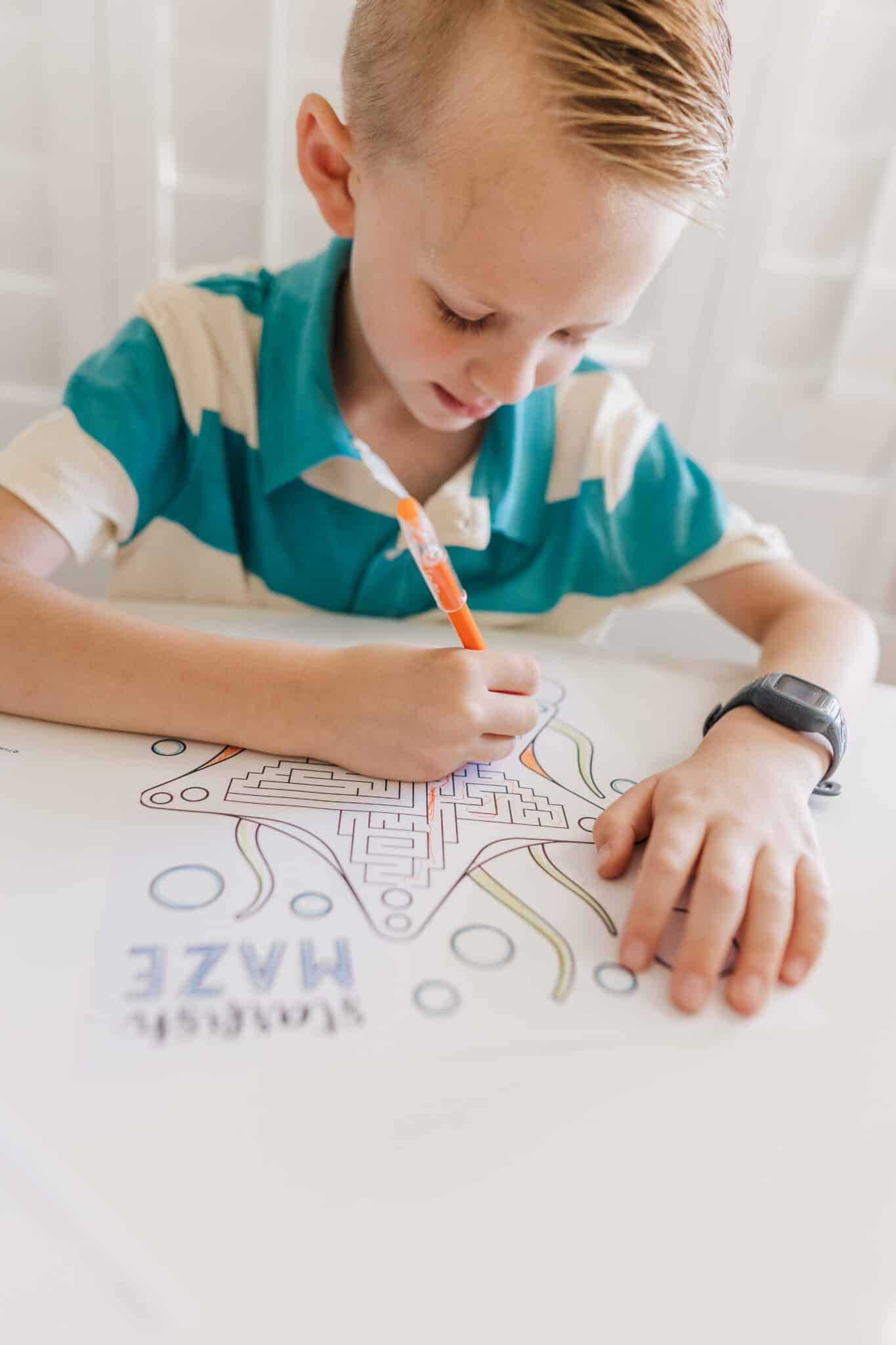 Mazes for Kids: kid doing a printable maze. 