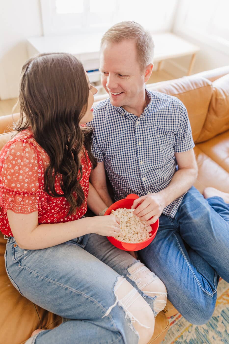 Couple on couch ready to watch the best 4th of July Movies. 