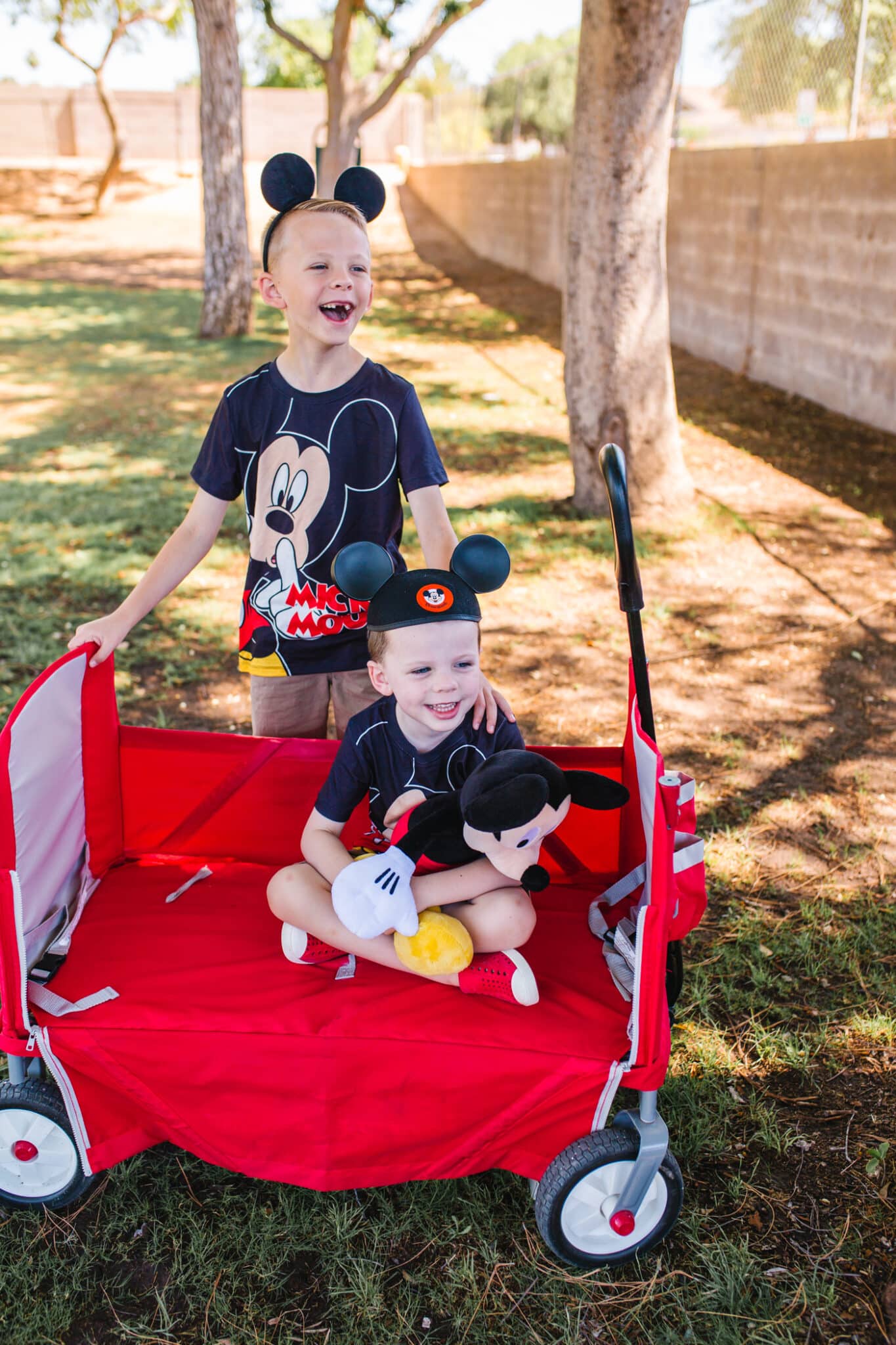 Boys dressed in Disney outfits: must pack items for success when prepping for a Disney vacation with a toddler. 