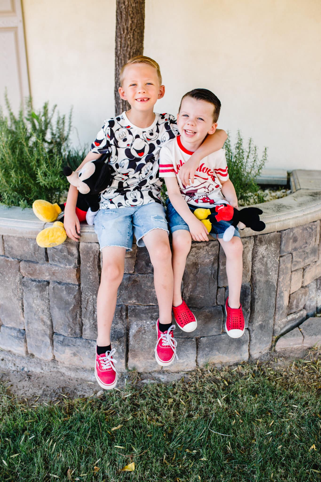 Boys dressed in Disney outfits: must pack items for success when prepping for a Disney vacation with a toddler. 