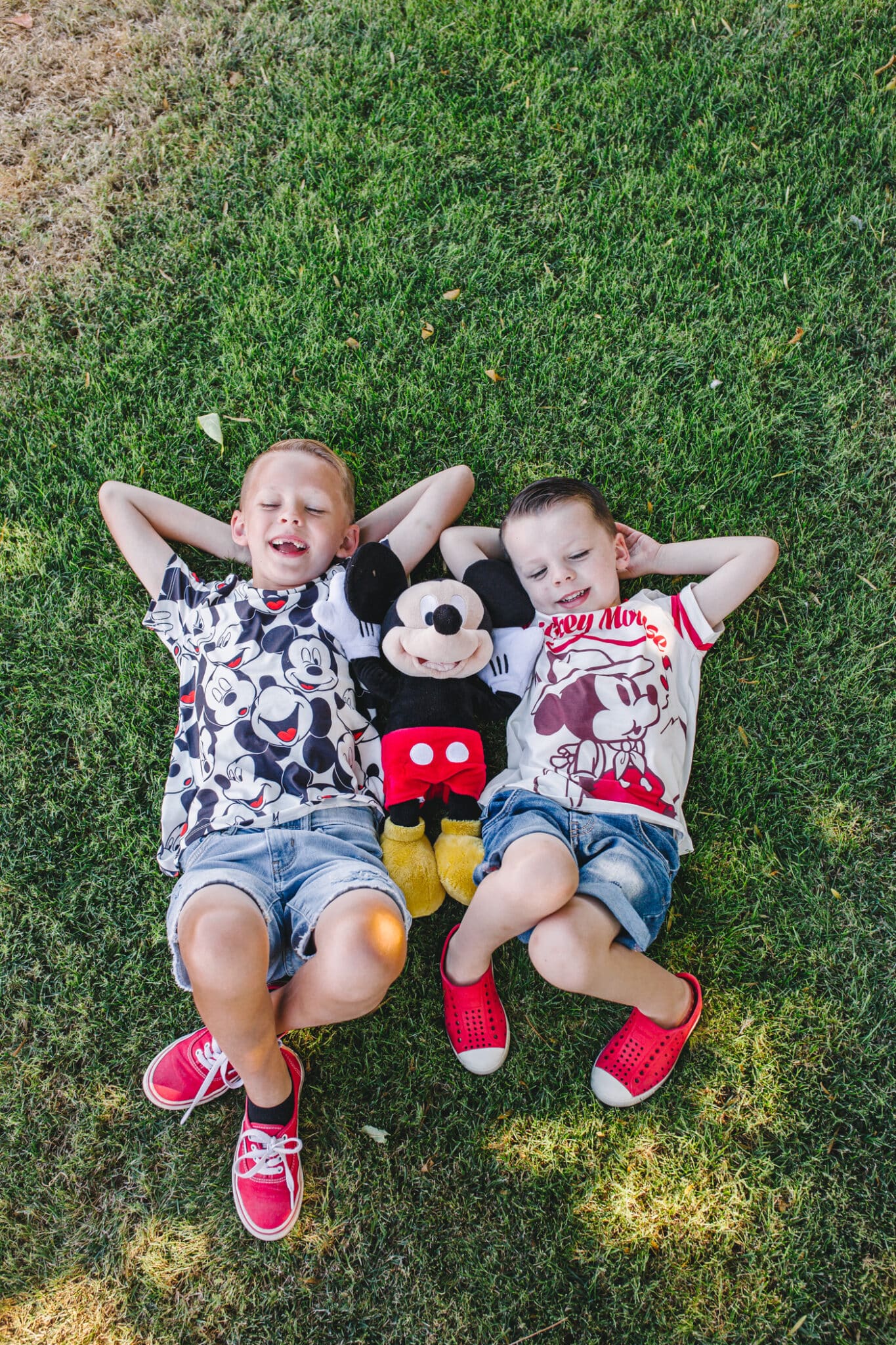 Boys dressed in Disney outfits: must pack items for success when prepping for a Disney vacation with a toddler. 