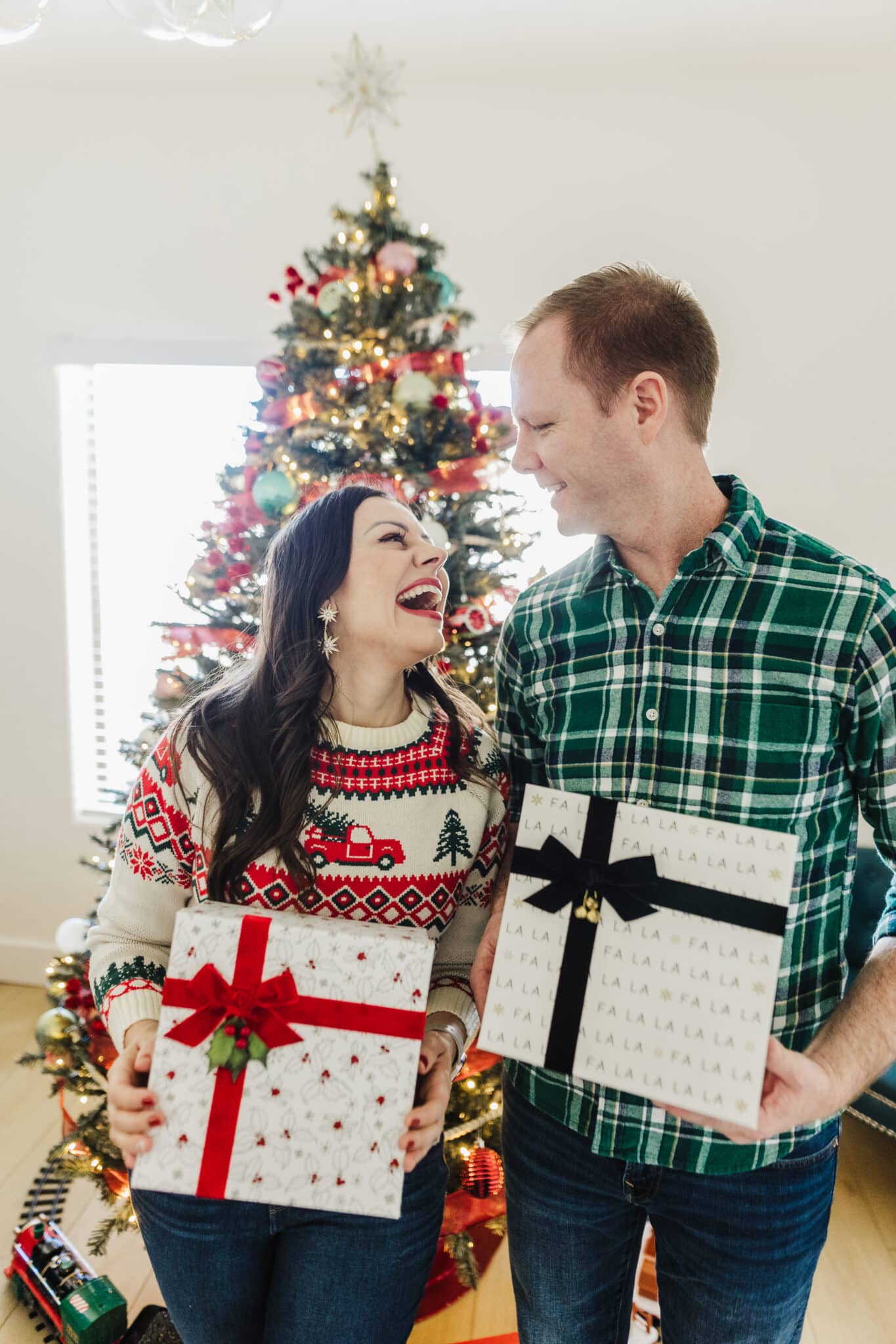 Couple holding presents sharing the top couples gifts for Christmas. 