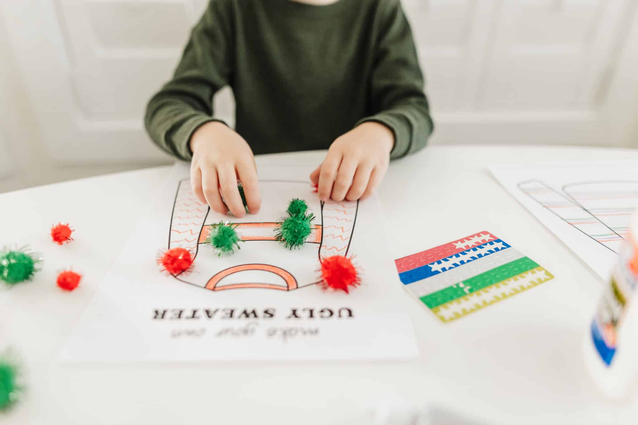 A boy decorating an Ugly Sweater craft for kids. 