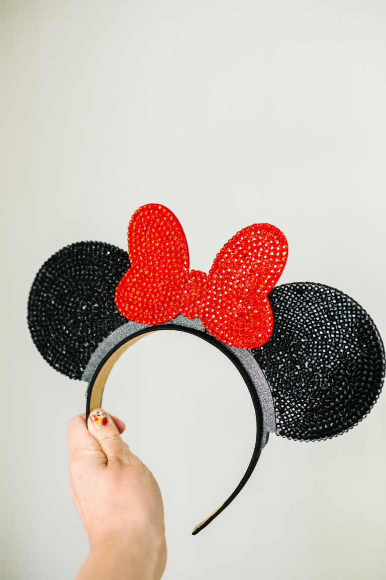 Rhinestone Mickey ears headband with Black Disney ears with a red bow.