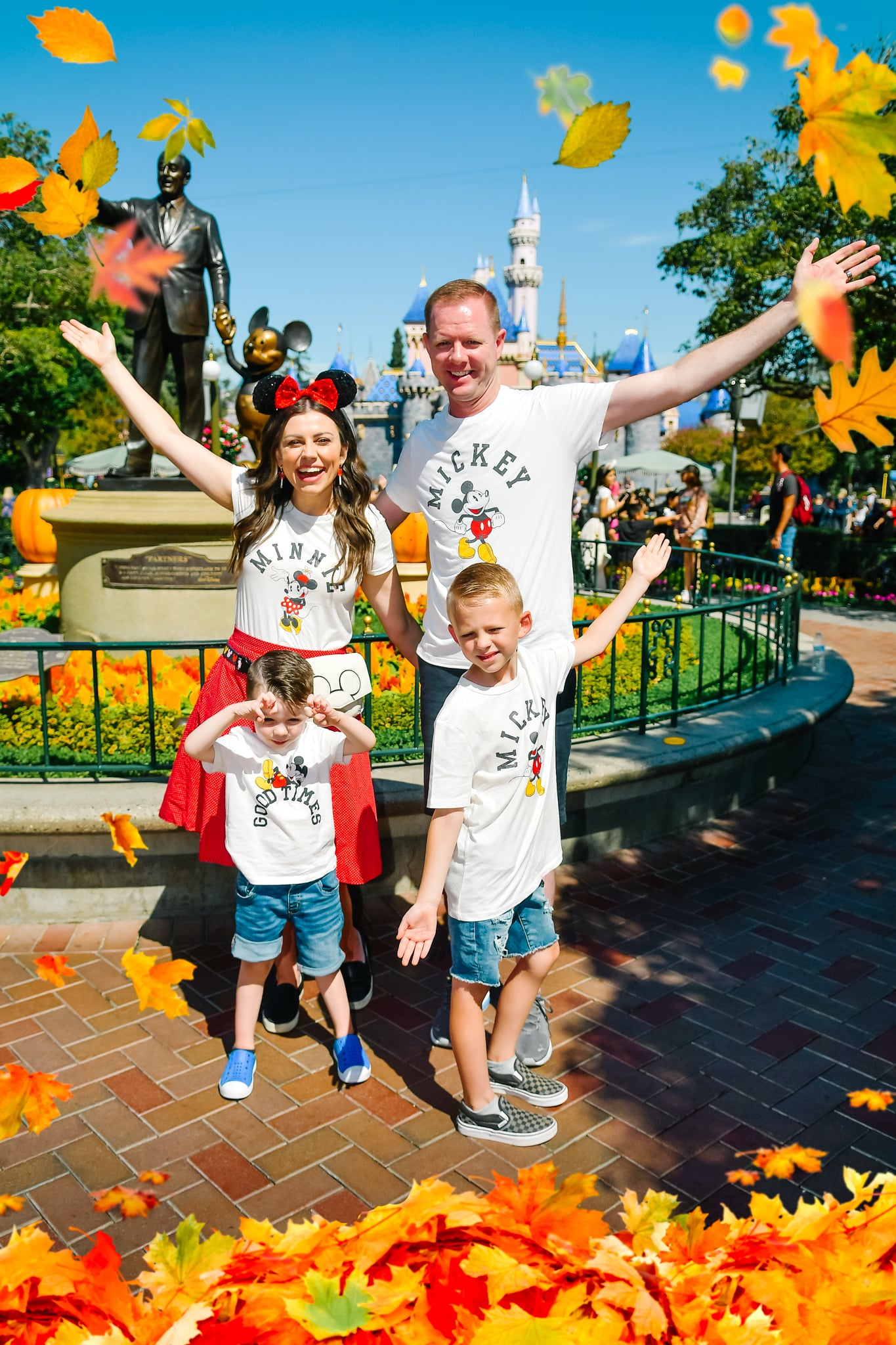 Family standing in from of Disneyland castle showing Disnelyand outfits as a guide of what to wear to Disneyland in the Fall. 