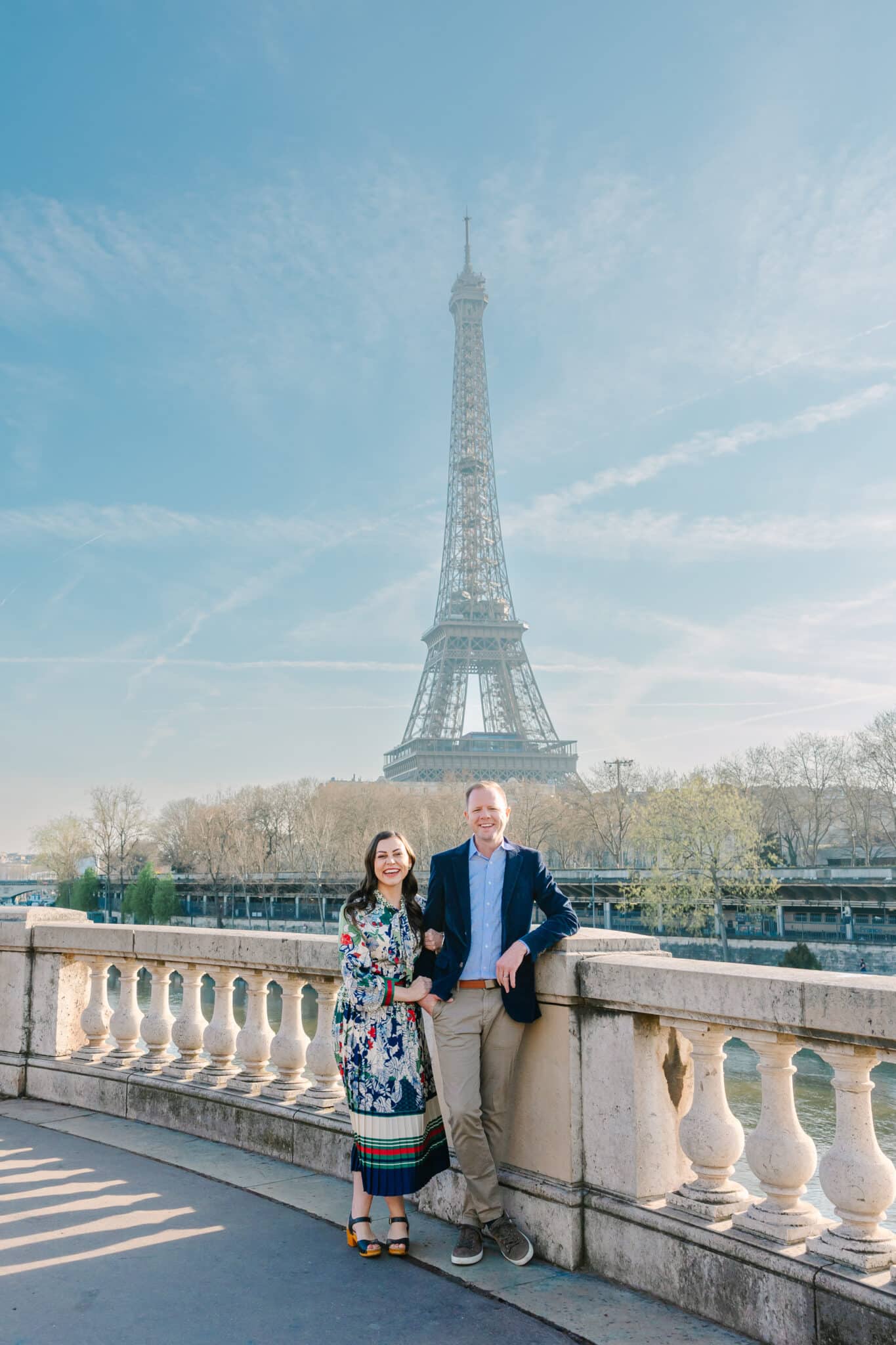 Flytographer photo shoot in Paris with a couple smiling in front of the Eiffel Tower. 