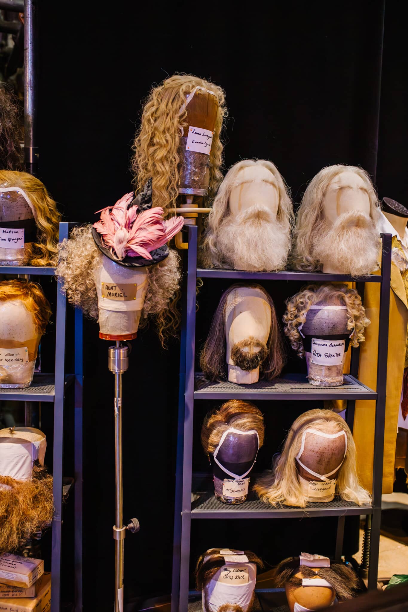 Harry Potter Studios costume design with a shelf full of wigs and costumes used in the Harry Potter films. 