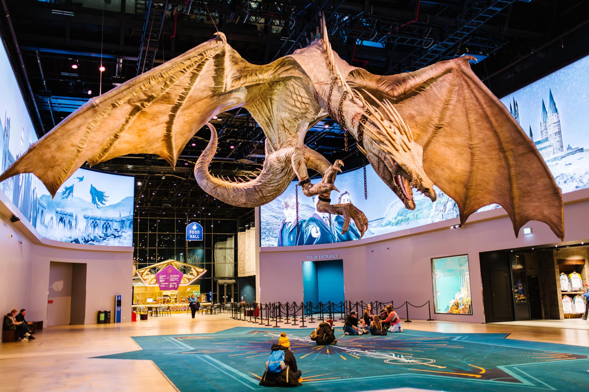 Harry Potter Studio Tour London Atrium welcoming area with dragon flying overhead. 
